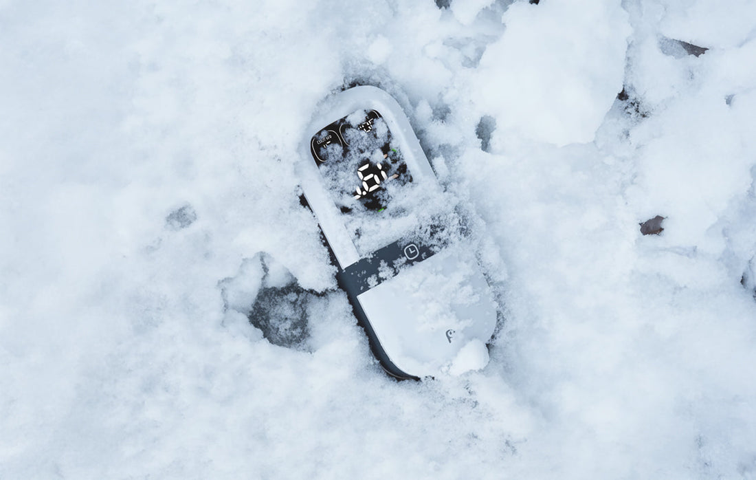 Rheidon Portable Charger partially buried in deep snow