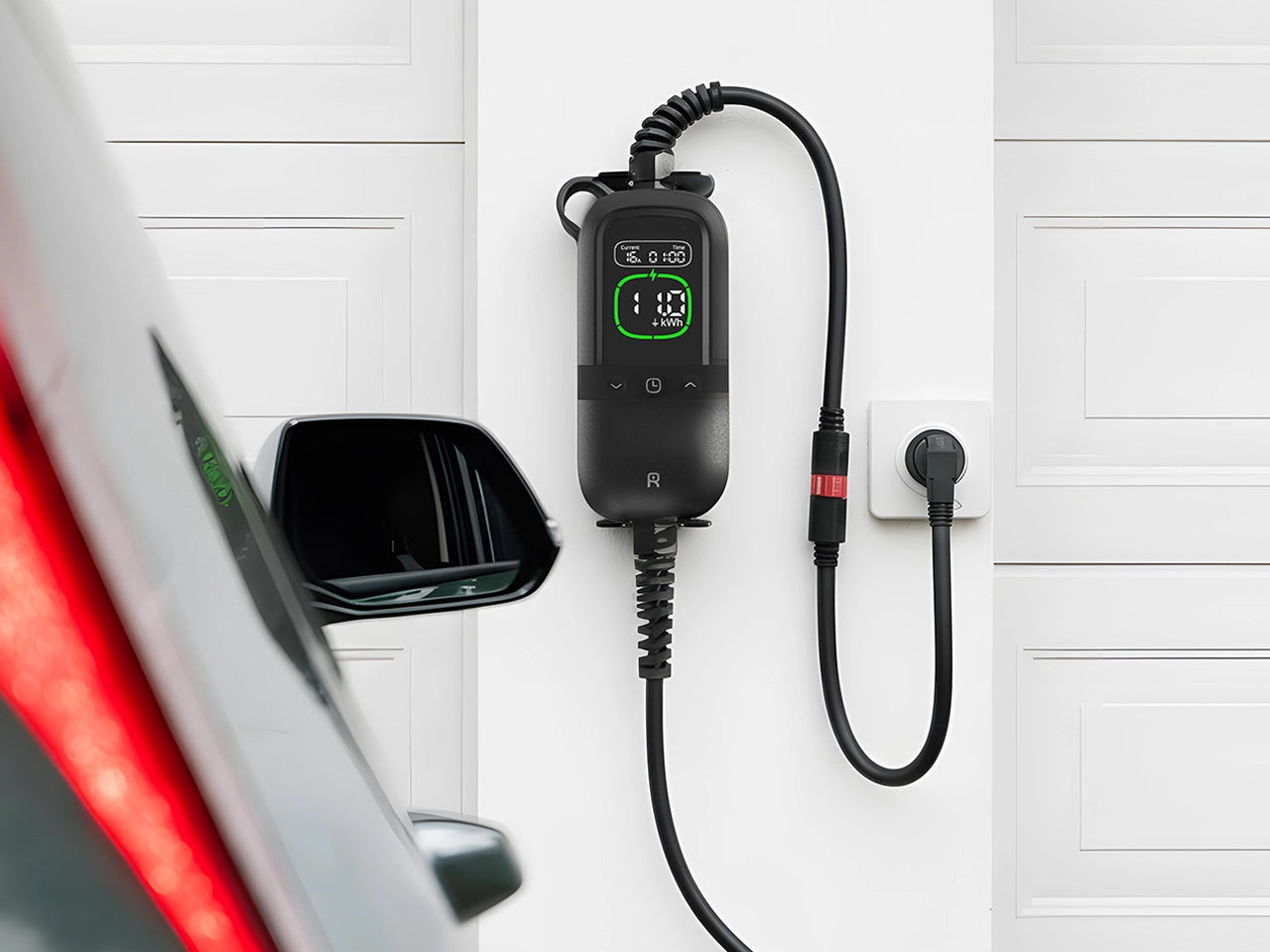 Rheidon PC200 Pro 11K portable EV charger plugged into a wall socket, charging an electric vehicle in a garage.